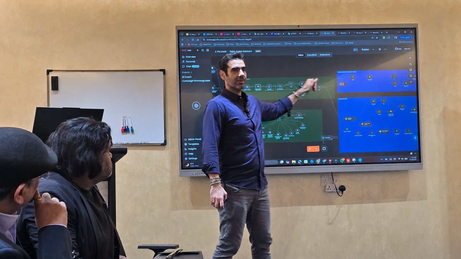 Community members listening attentively as Sam Fouladgar leads a live AI workflow demonstration at the IBW Center of Excellence, Doha.