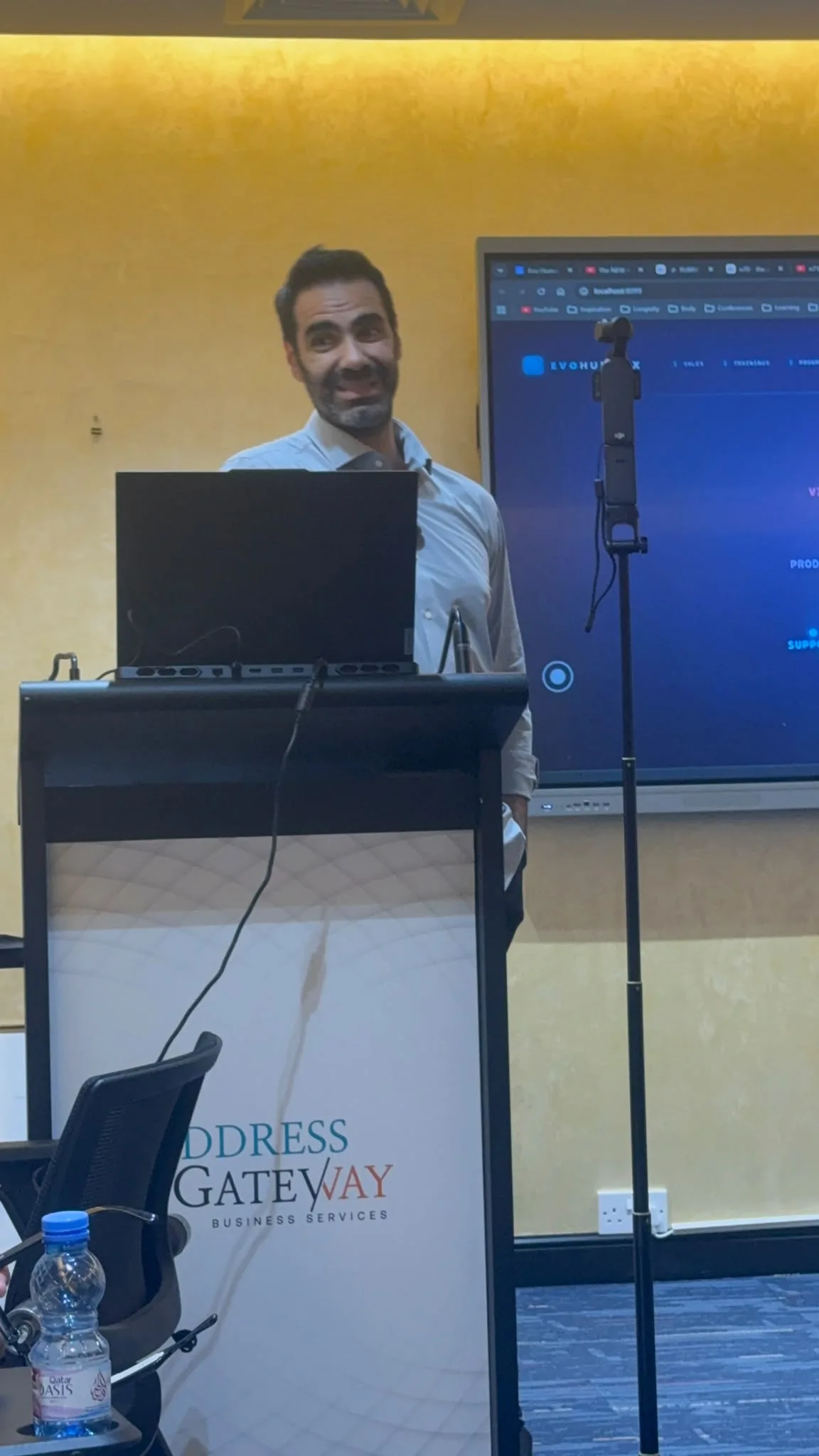 A speaker at the podium during the AI Innovation Showcase in Doha